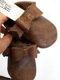 Floral embossed brown leather moccs with short fringe and bows