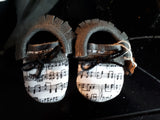 Grey moccs with music toe topper short fringe and black lacing bow